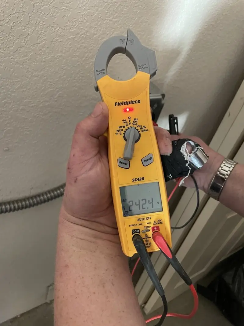 Voltage testing with clamp meter during Outlet Installation in Williamsburg